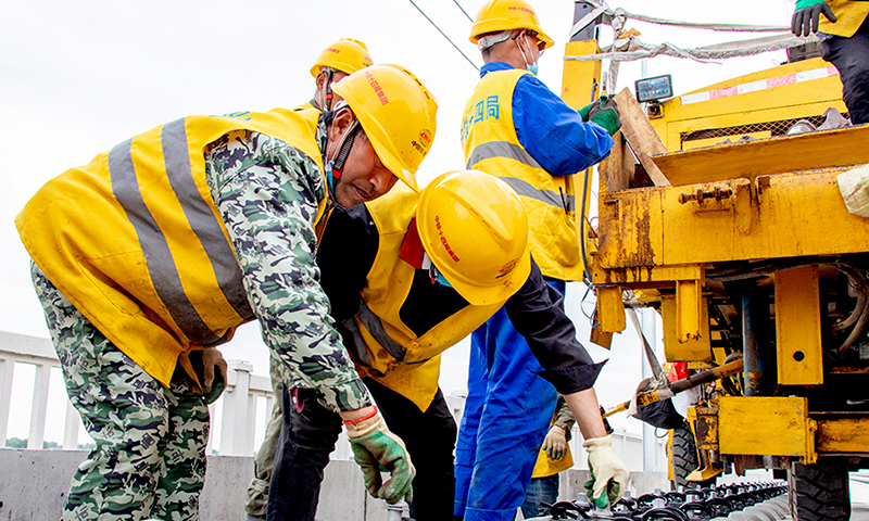 為確保施工安全，項目部引入可視化行車調度系統，并研發遠端智能防護報警器，實現了工程線運輸安全預警從人工到智能化、信息化方式的轉變，在全線推廣使用。同時對運軌便線沿線道口實現24小時不間斷視頻監控。他們在國內率先將營業線LKJ行車自動裝置引入工程線施工中，通過線路上的感應器與機車上的接收器防止車輛超速、溜逸，提升了運輸效率和安全管控水平。圖為施工人員確保質量精益求精。
