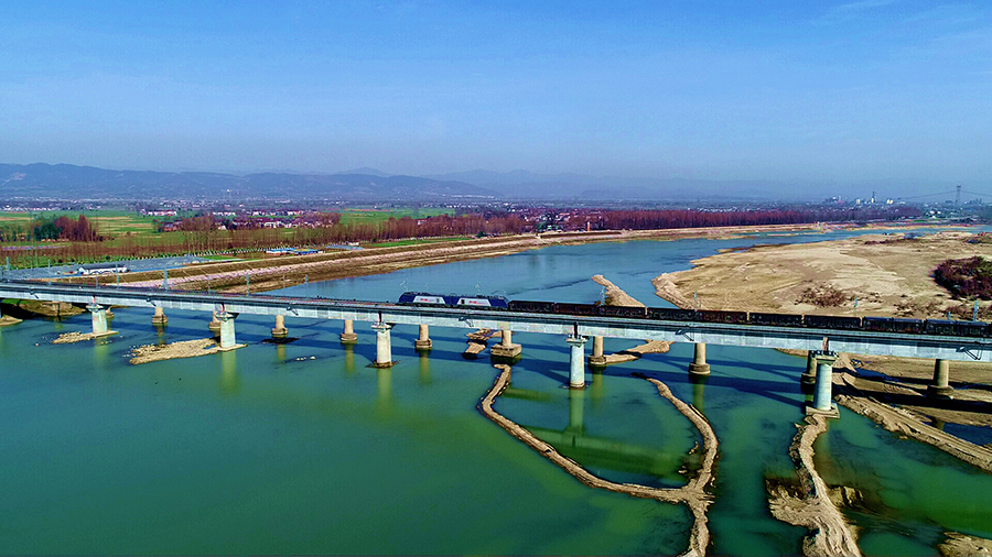 2019年12月27日，由中國鐵建所屬鐵一院設計，中鐵十一局、中鐵十二局、中鐵十四局、中鐵二十局、中鐵二十五局、中鐵建電氣化局等單位參建的陜南鐵路大動脈陽（平關）安（康）鐵路二線順利開通。圖為列車駛過中鐵十四局承建的洋縣漢江特大橋。（肖永順 攝）