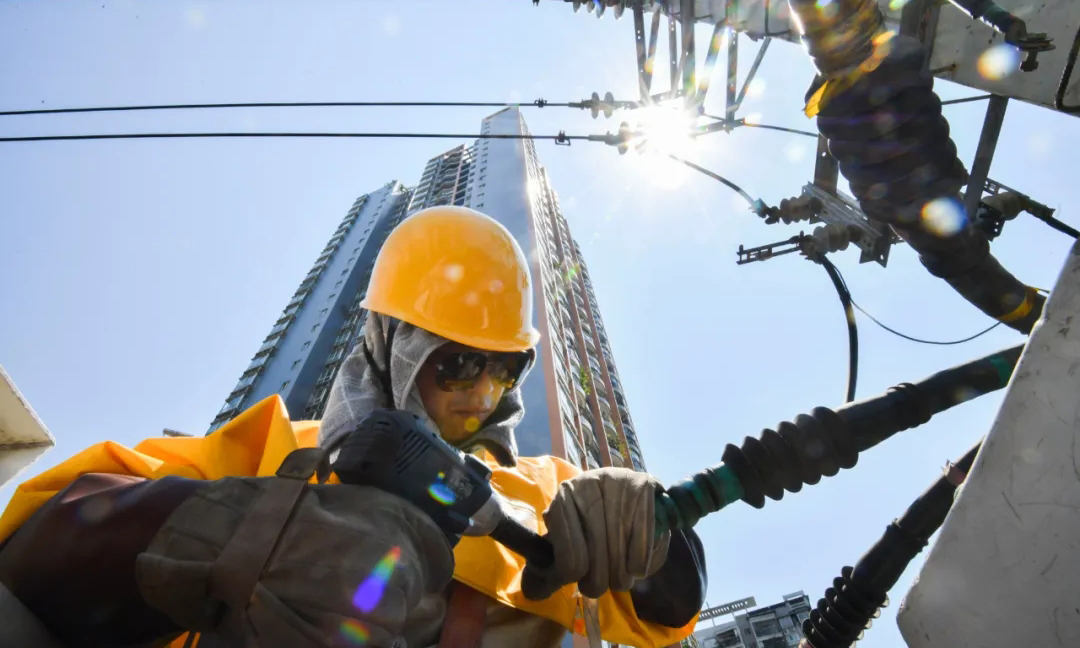 國網重慶電力科學合理布置搶修站點158個，組織國家電網紅巖共產黨員服務隊113支、應急搶修隊伍139支，調配搶修人員5652人、應急搶修車730臺、應急發電車51臺，在遭受外力破壞、設備故障、極端天氣等造成突發停電時，迅速開展故障搶修和應急保電，全力做好電力迎峰度夏保障工作。圖為國網重慶電力帶電作業人員在烈日下拆除故障線路。