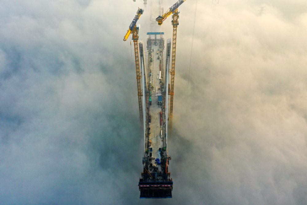 11月15日，中鐵四局建設者在100余米的高空進行斜拉索掛索及懸臂節段掛籃懸澆作業。