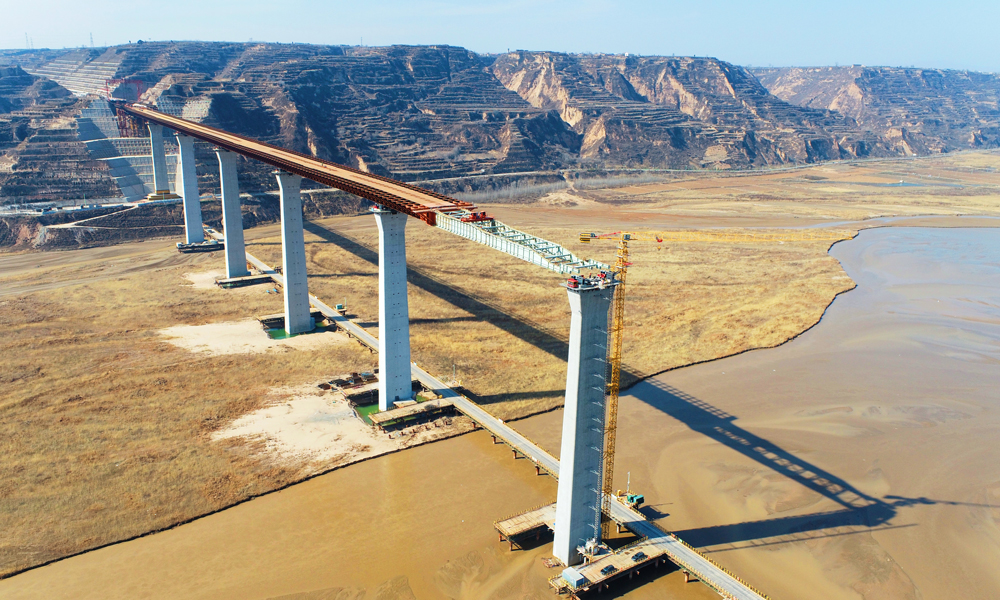 近日，由中國鐵建旗下鐵建投資投資、中國鐵建大橋局施工的臨猗黃河大橋再傳捷報。該橋山西、陜西雙側頂推成功突破1600米大關，為全年頂推施工任務完成及鋼箱梁合龍奠定了堅實基礎。圖為大橋頂推施工現場航拍。