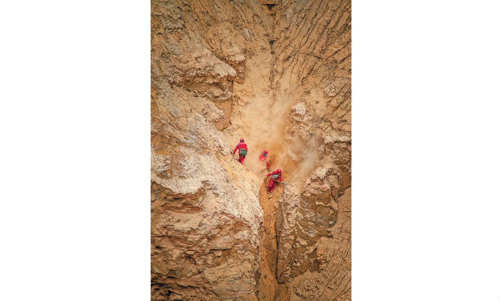 獅新58井區三維項目是青海油田增儲上產的重要區塊，項目工區海拔2850—3697米，山地占比78%。青海物探處整合優勢資源，集中力量，投入外接式節點采集設備9萬道，山地鉆機100臺，運載設備250臺（套），施工人員2500余人。圖為物探隊員在柴達木盆地英雄嶺地區高原山地進行測量作業。呂殿杰 攝