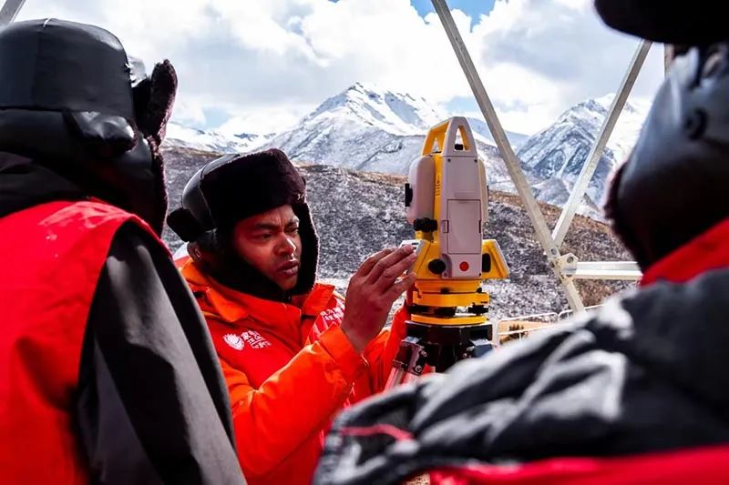 國家電網西藏電力工作人員在那曲榮布—巴達35千伏線路工程現場開展測量工作。