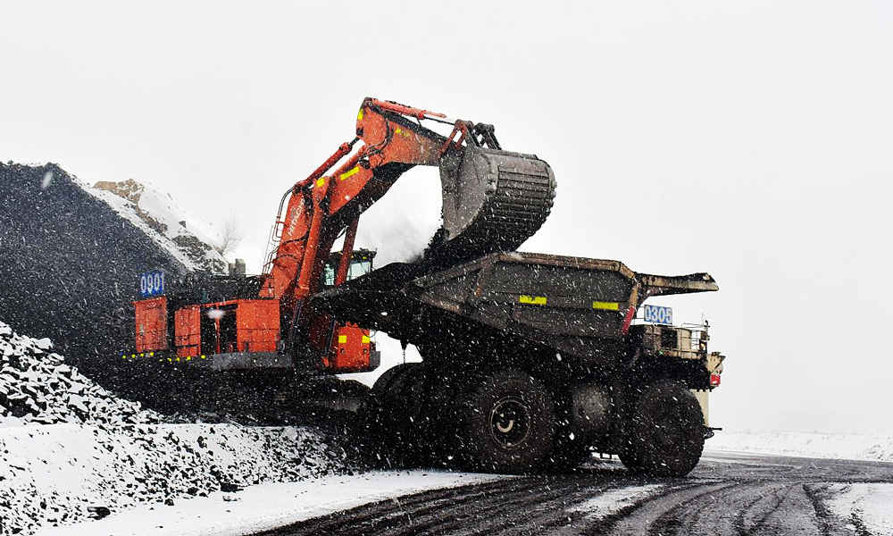 準能集團哈爾烏素露天煤礦在降雪天氣前加大場地存煤，最大限度減少天氣對上煤工作的影響，確保原煤生產的穩定接續。圖為液壓反鏟在降雪天氣為卡車裝煤。