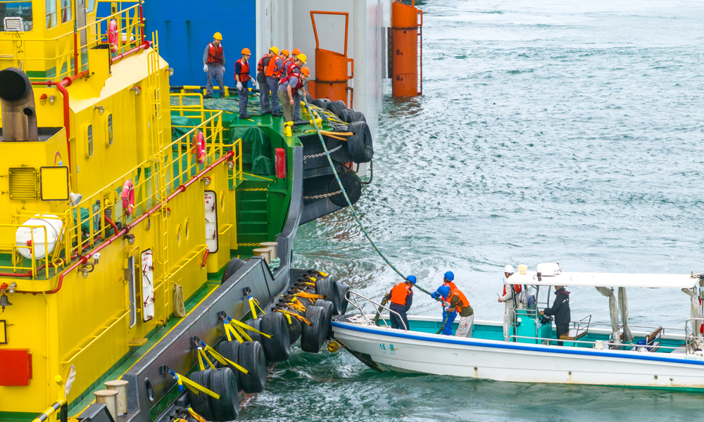“‘?？惶?hào)’運(yùn)抵珠江口盆地的流花油田后，將通過12根長達(dá)2570米的系泊纜繩牽引，漂浮在水深324米的大海上工作，每天能處理約5600噸原油。”中國海油深圳分公司流花油田開發(fā)項(xiàng)目組安裝負(fù)責(zé)人介紹。圖為施工人員在浮卸作業(yè)過程中，為“?？惶?hào)”掛載濕拖纜。