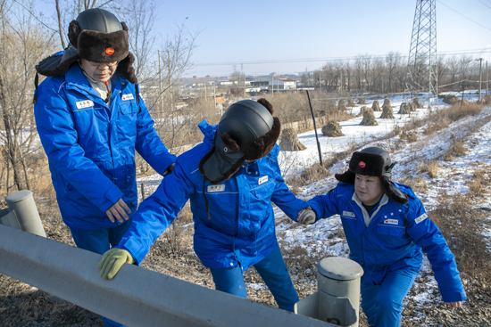 圖為員工翻越管道和橋梁交界處，檢查原油管道運行情況。王志強 攝.jpg